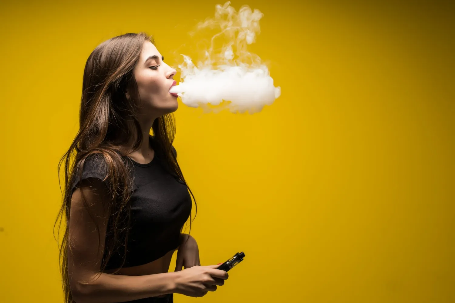 young-woman-standing-vaping.webp